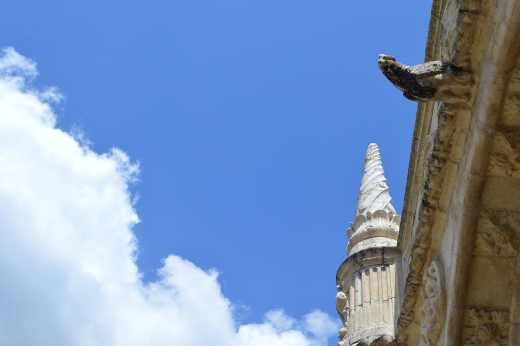 Pináculo de piedra junto a cielo azul y nubes.